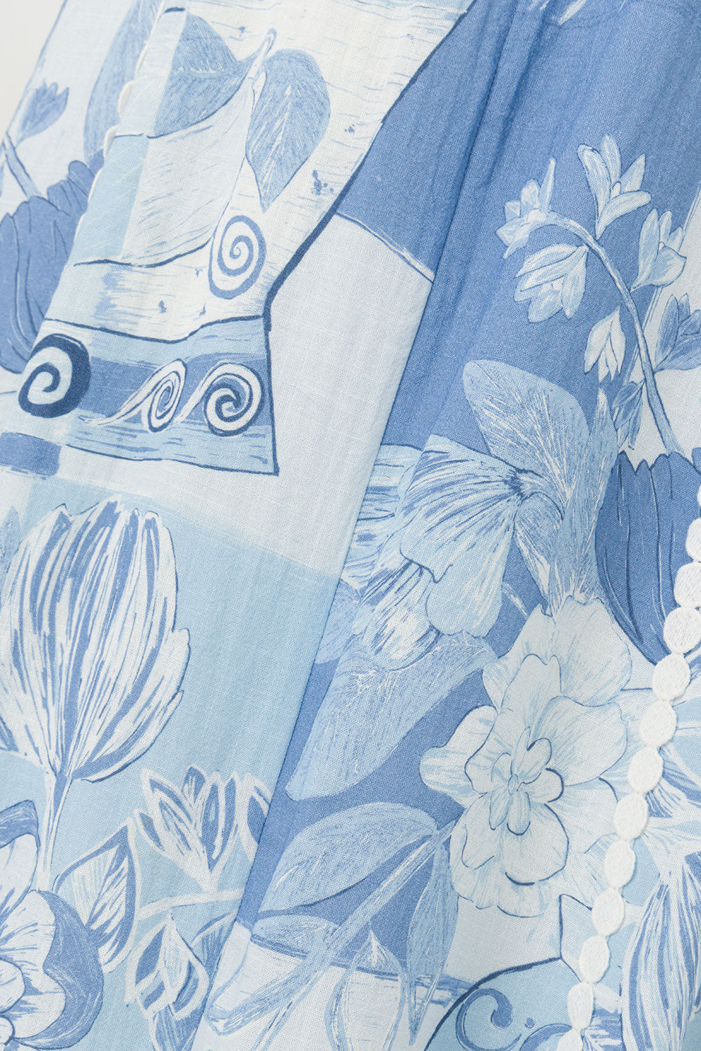 Close up of the blue and white vase and floral patchwork print fabric