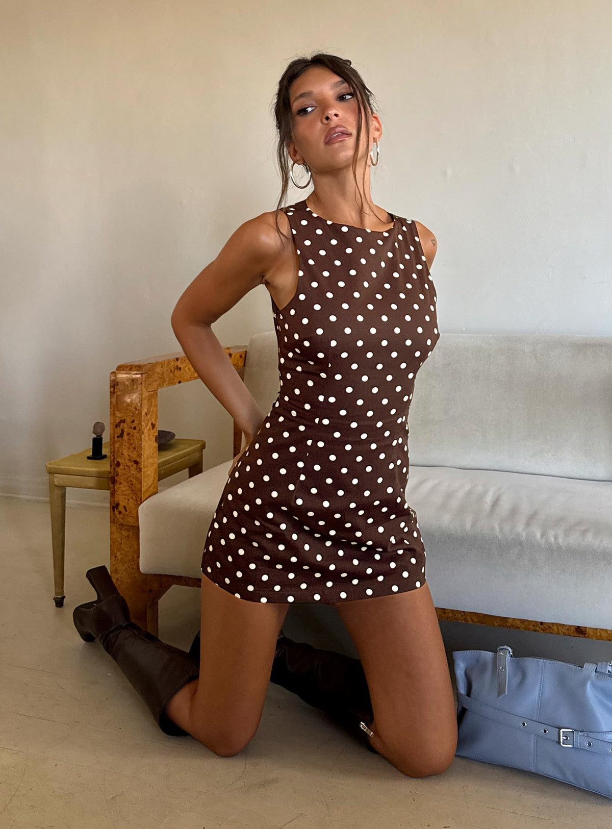 Full length view of a model wearing the brown polka dot sleeveless playsuit