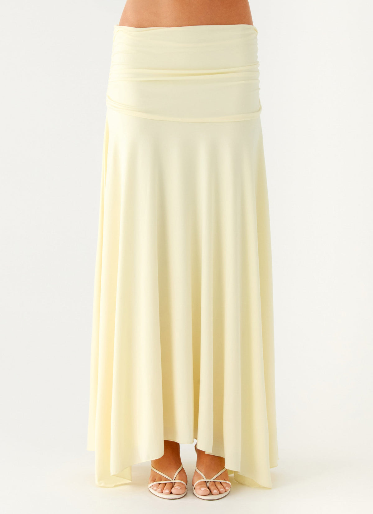 Close view of the yellow ruched maxi skirt showing the gathered low-rise waistband