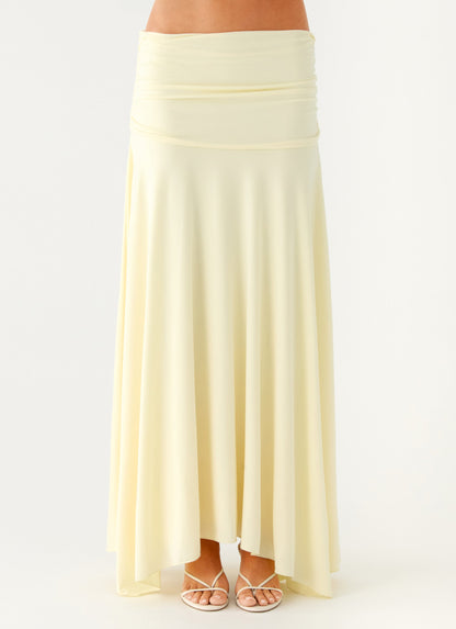 Close view of the yellow ruched maxi skirt showing the gathered low-rise waistband