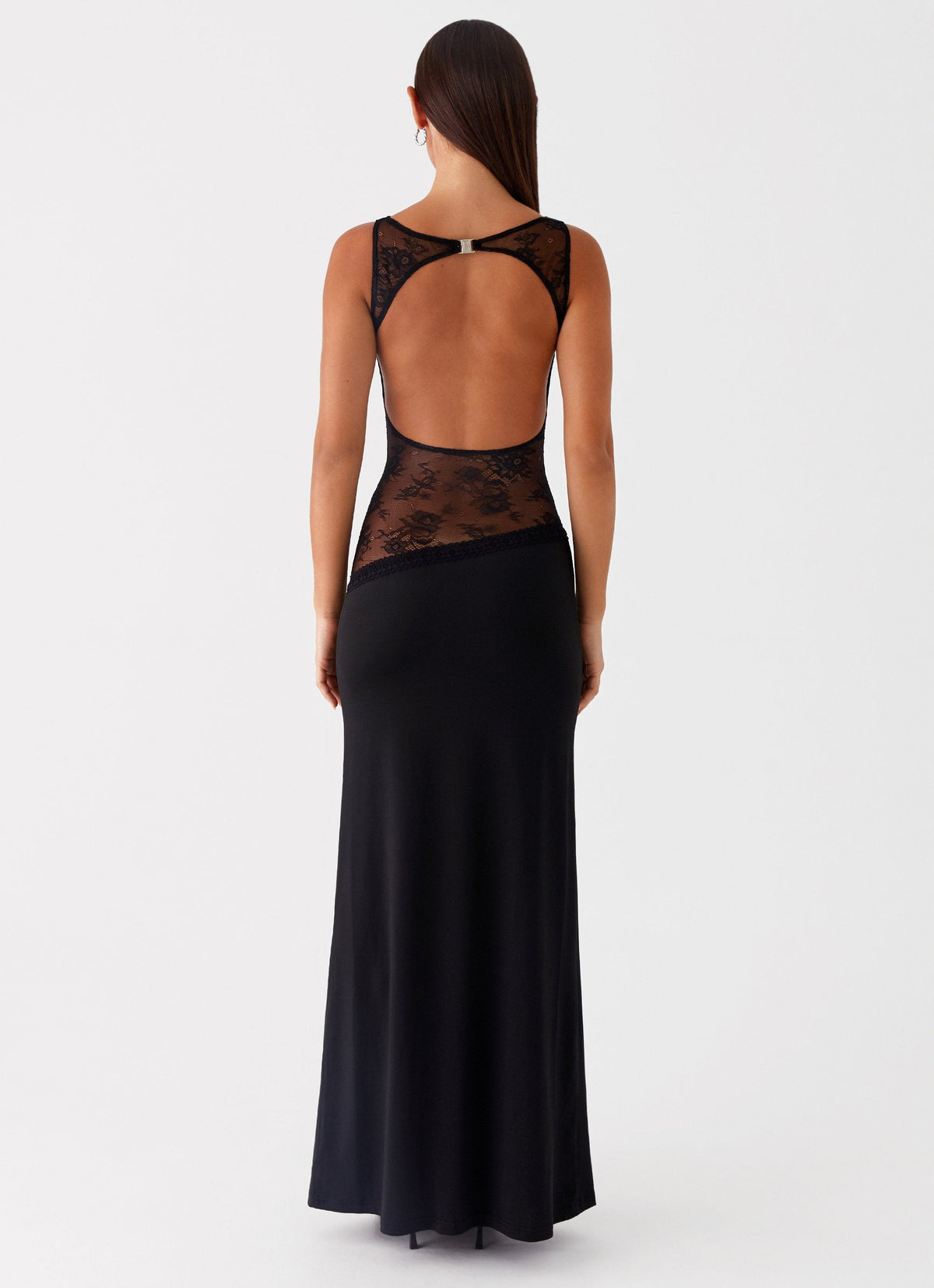Back view of the black maxi dress showing the open lace back and ring closure at the neck