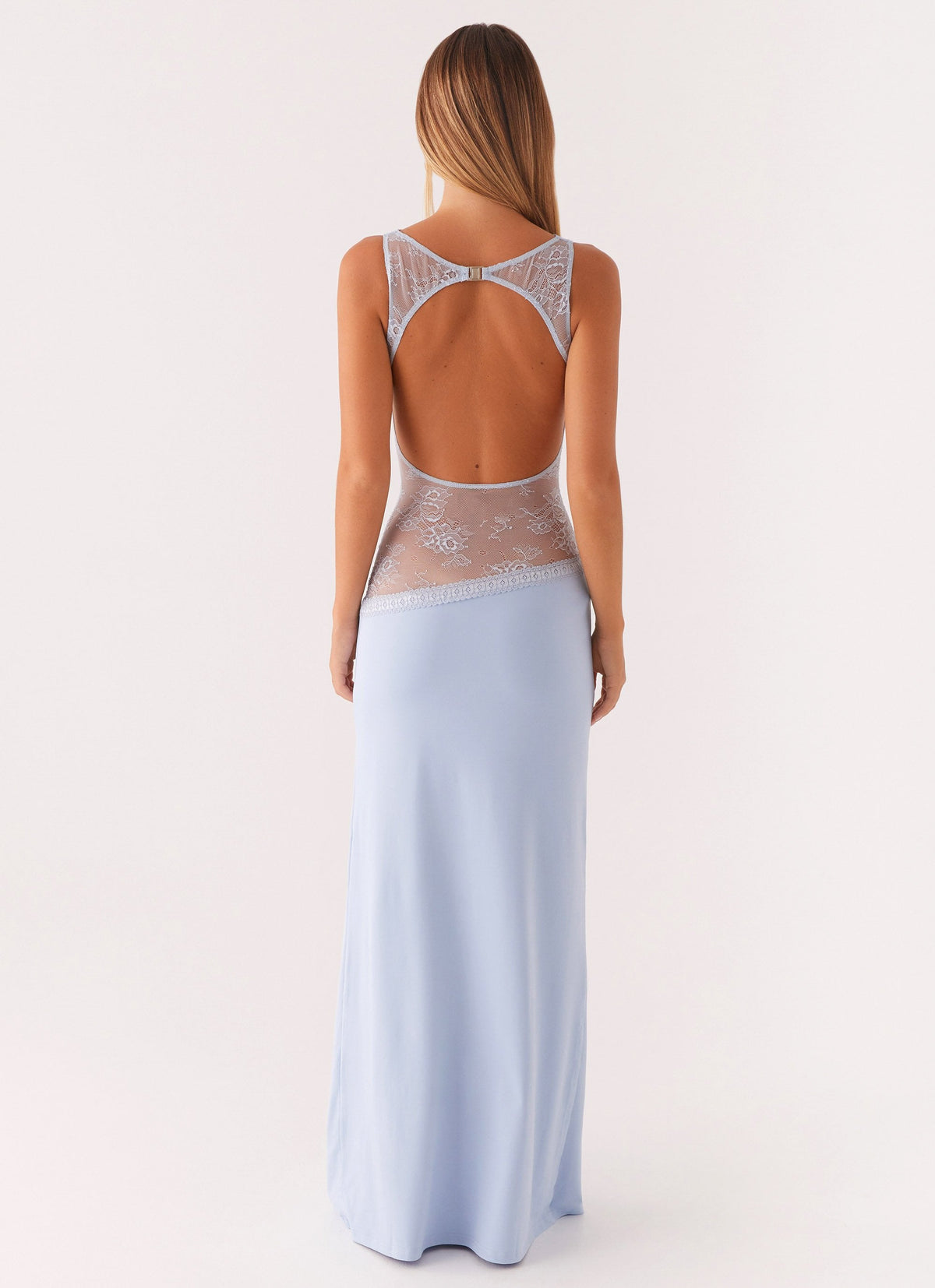 Back view of the blue maxi dress showing the lace-trimmed open back cut-out