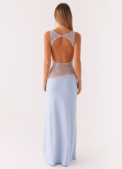 Back view of the blue maxi dress showing the lace-trimmed open back cut-out