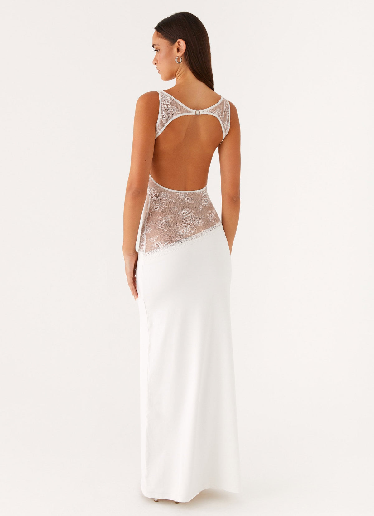 Back view of the white maxi dress showing the lace-trimmed open back cut-out