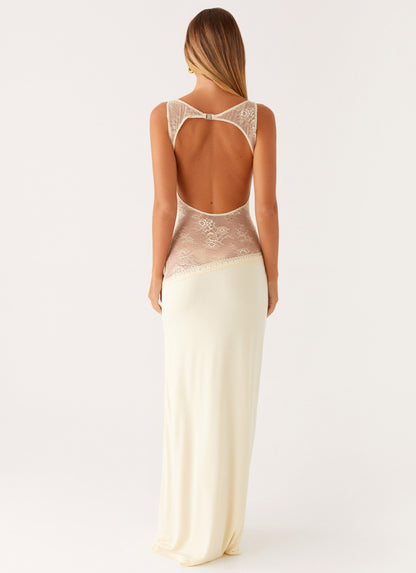 Back view of the yellow maxi dress showing the lace-trimmed open back cut-out