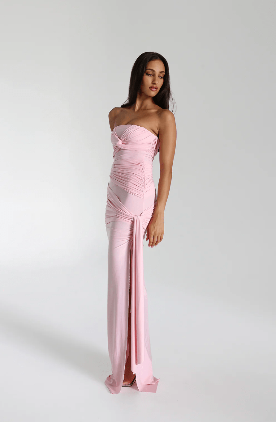 Side view of the blossom pink strapless maxi gown showing the side split and hanging tie