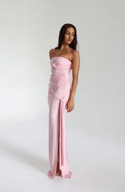 Side view of the blossom pink strapless maxi gown showing the side split and hanging tie