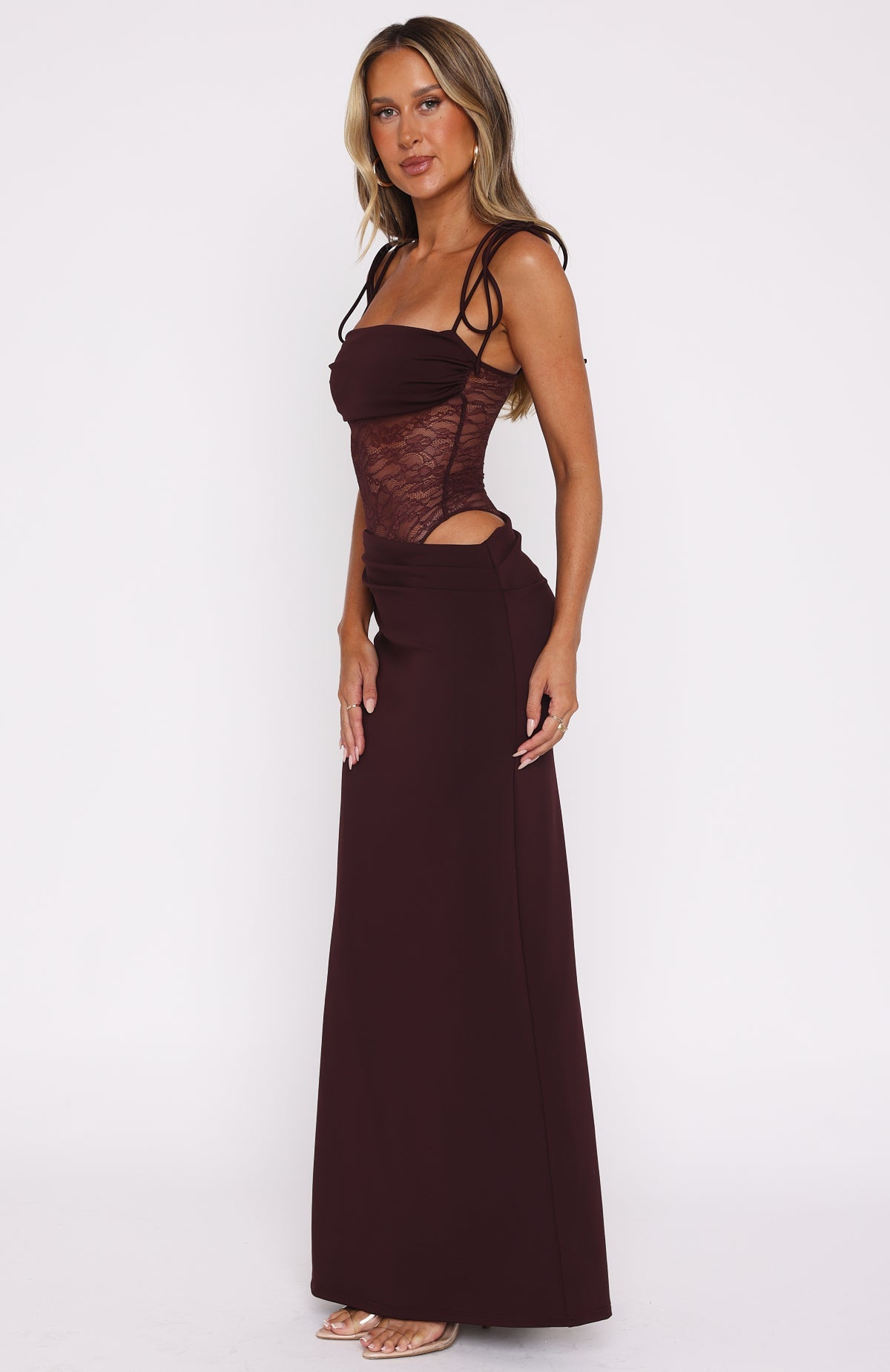 Side view of the burgundy maxi dress showing the waist cut-out below the sheer lace bodice