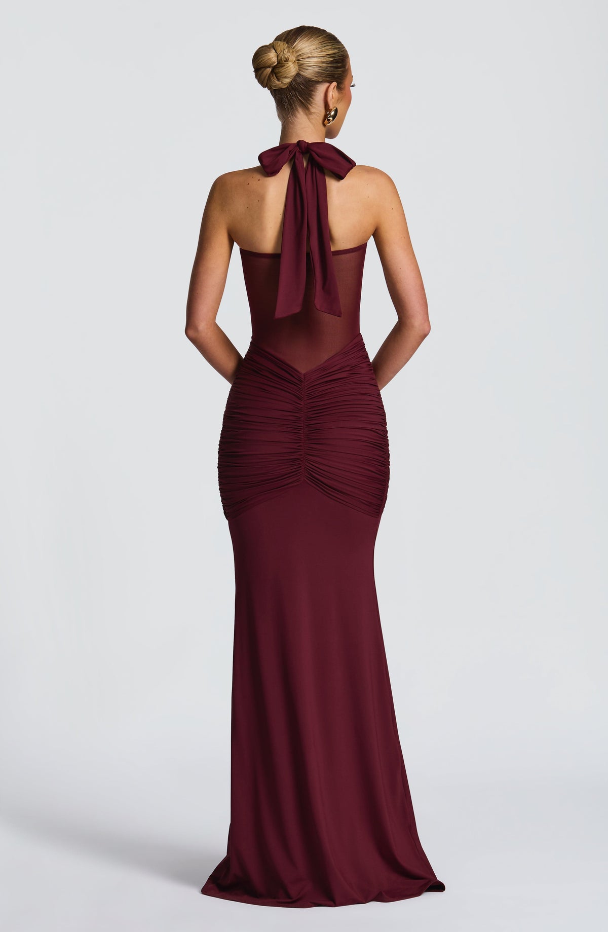 Back view of the cherry lacquer maxi dress showing the open mesh back and halter neck tie