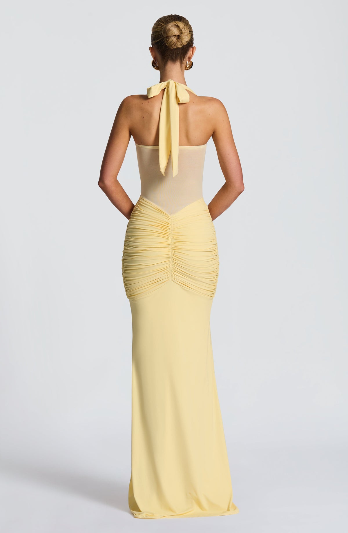 Back view of the lemon maxi dress showing the open mesh back and halter neck tie