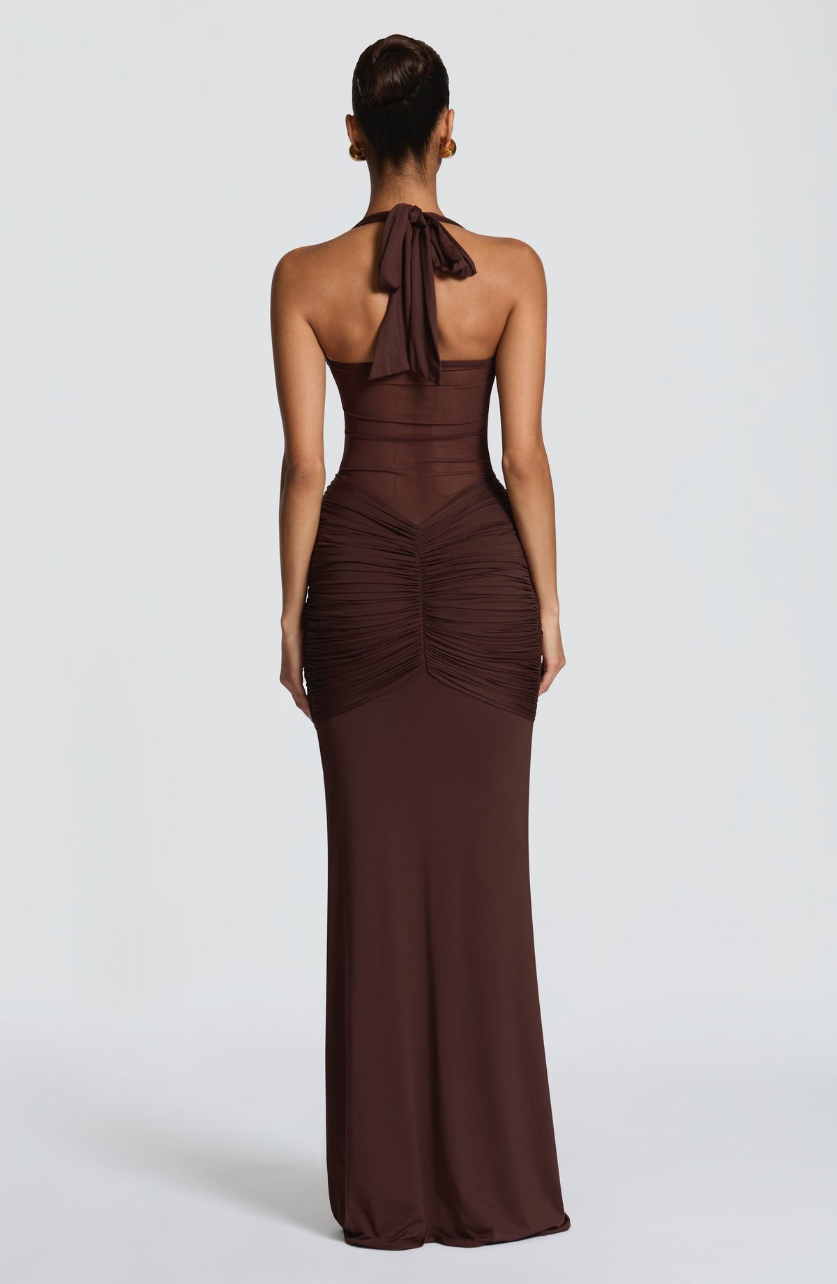Back view of the plum brown maxi dress showing the open mesh back and halter neck tie