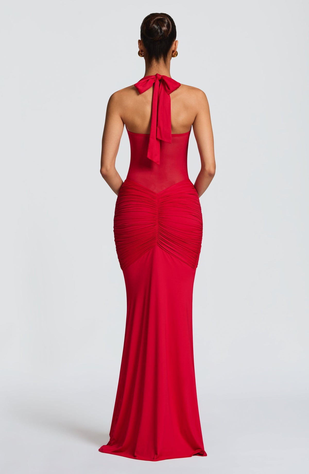 Back view of the red maxi dress showing the open mesh back and halter neck tie