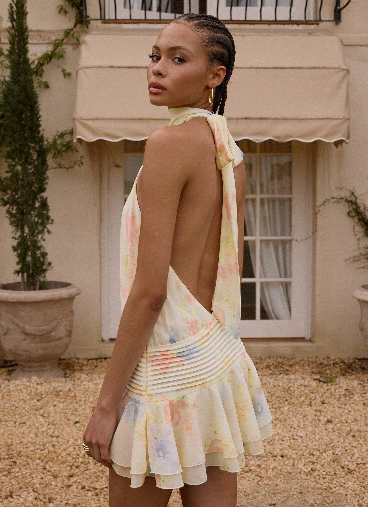 Back view of the spring meadow halter neck mini dress showing the open back and tie neck strap