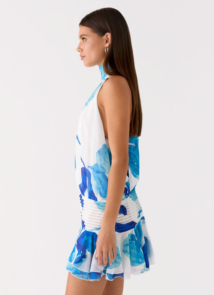 Side view of the cerulean bloom chiffon halter neck mini dress showing the drop waist and flared hem